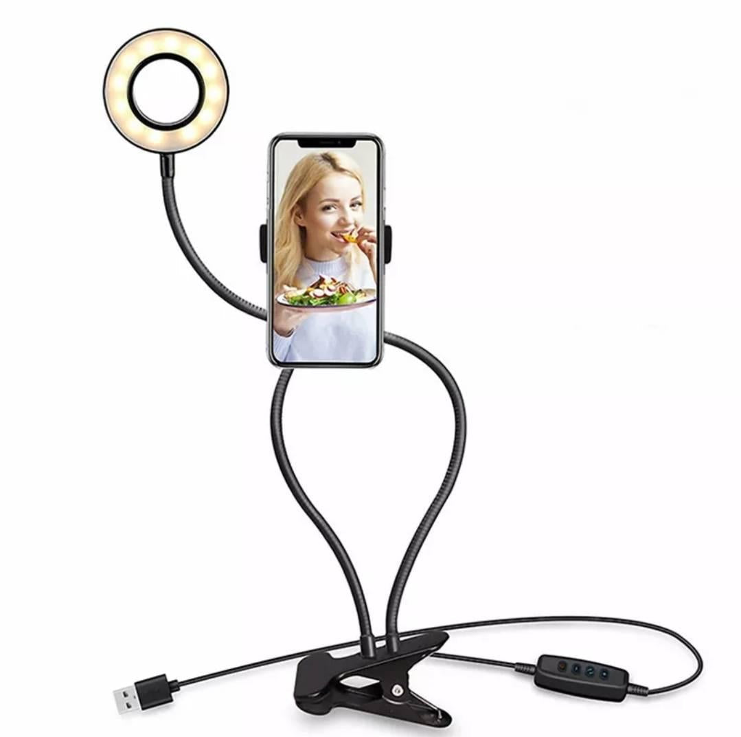 Prikazana je LED prstenasta lampa sa držačem telefona i stezaljkom.