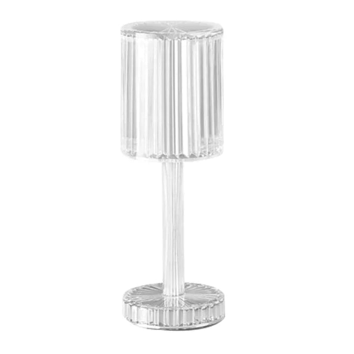 Lampa za sto sa kristalnim izgledom i valjkastom siluetom.