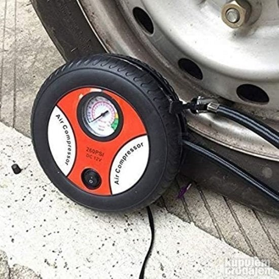 Prikazan je električni kompresor za gume marke PRODAVANI.